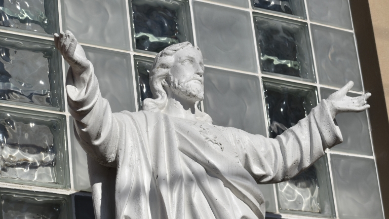 Statue of Jesus in front of school.